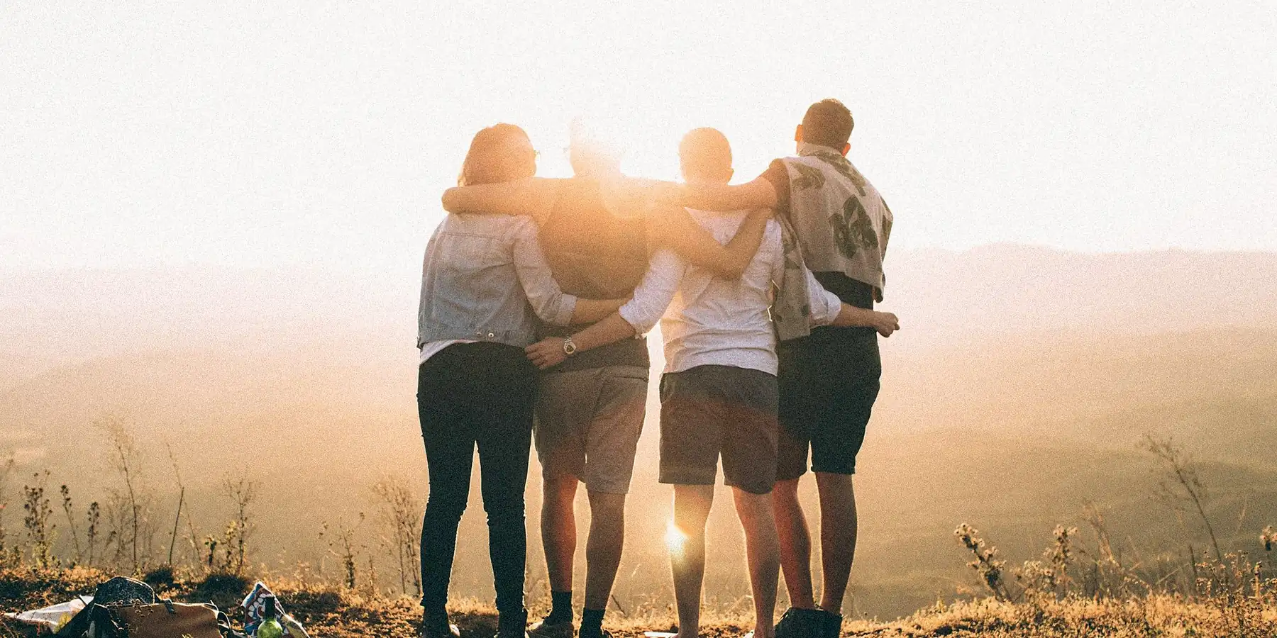 A family standing together at sunset