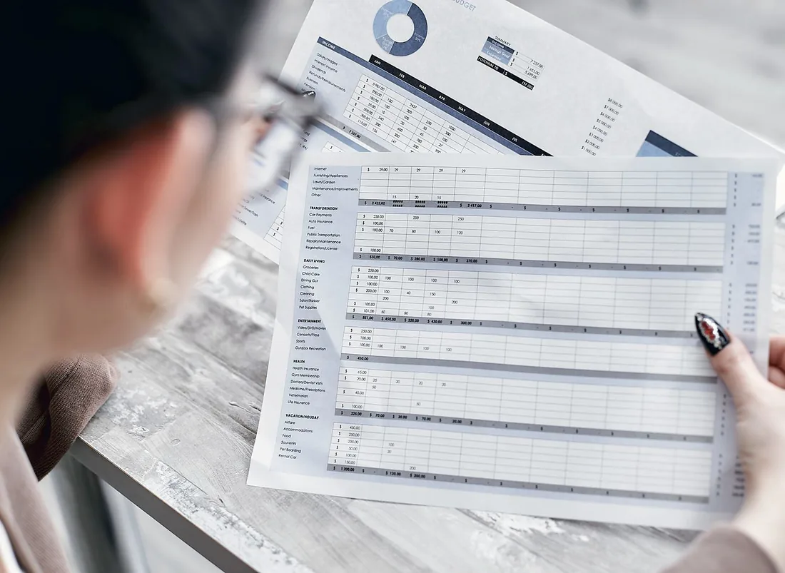 A couple reviewing a financial statement with their advisor